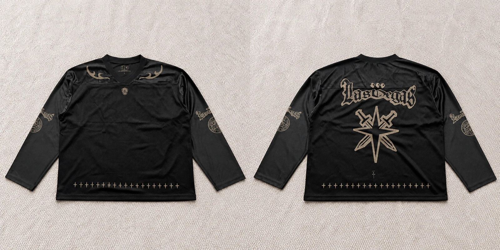 Front and back views of a dark long-sleeve jersey with gold-toned graphics.